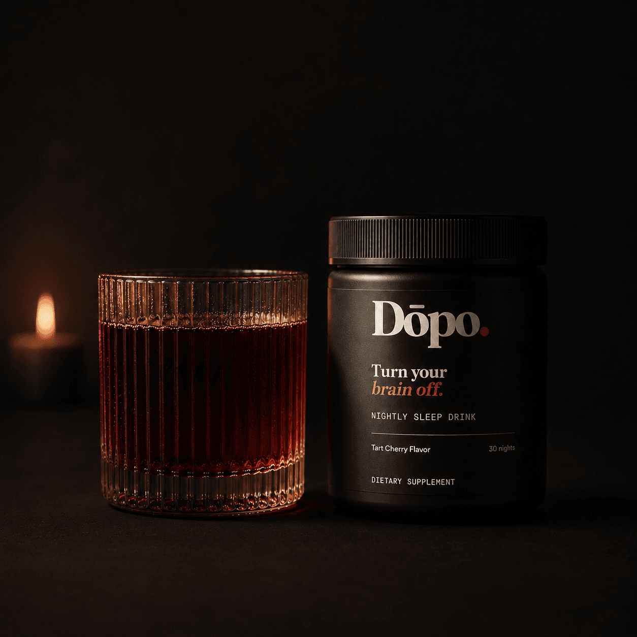 Dōpo Tart Cherry nightly sleep drink tub on a near-black backdrop with a warm amber rim light