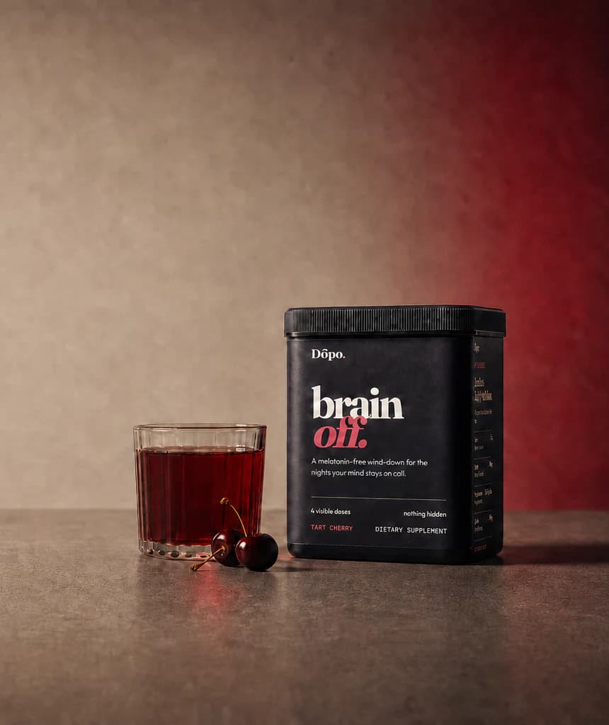 The black Dōpo Brain Off tub beside a glass of tart cherry